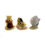 A group of eight Royal Doulton Winnie the Pooh figures, including Winnie the Pooh in Armchair,