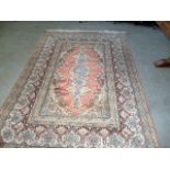 An Eastern style carpet, with central floral medallion, surrounded by a multi-border, approx 280cm