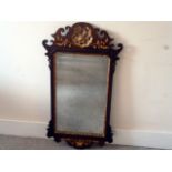 A Regency style mahogany fretwork mirror,  having bevelled glass, carved and gilt designs