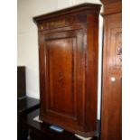 A George III inlaid corner cabinet, having central inlaid shell cartouche to door, approx 105cm H