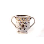 A late 18th/early 19th century twin handled cup, having floral decoration, AF