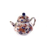 A Chinese porcelain teapot and cover, decorated in red and blue floral design