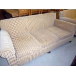 A three seat roll arm sofa, upholstered in striped fabric