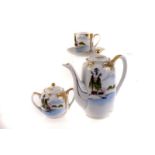 A Kutani ceramic four piece tea set, having oriental style lake scene decoration, comprising tea