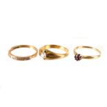 An 18ct gold diamond ring, together with a 14ct gold garnet ring and a 9ct gold diamond ring, having