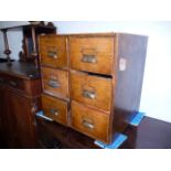 A small oak index cabinet, having two banks of three small drawers