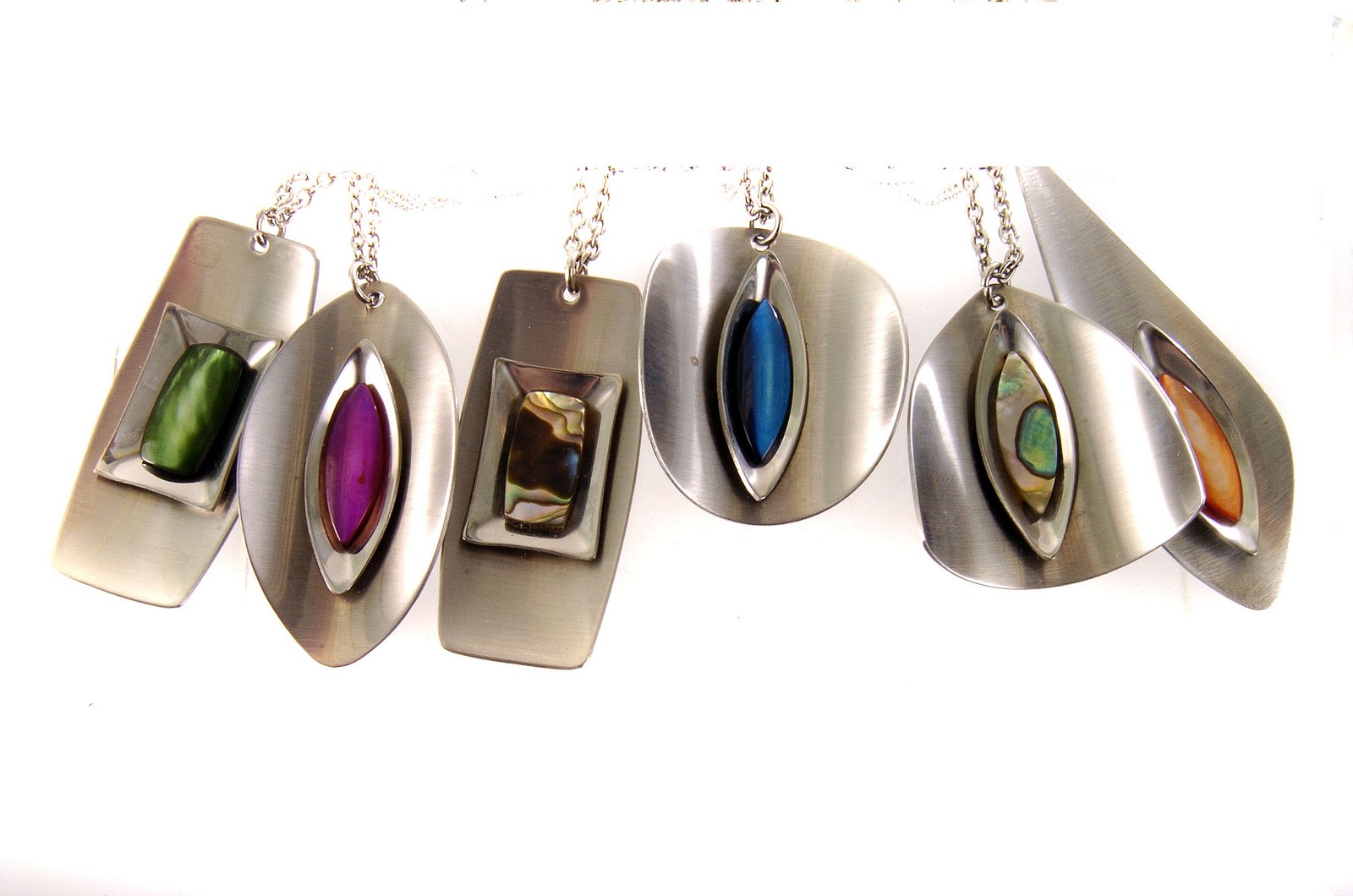 Six 1960s stainless steel and enamel pendants