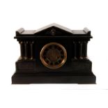 An Edwardian slate mantle clock, with architectural themes, with classical style warrior relief