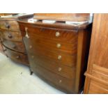 A mahogany bow fronted chest of drawers, having five long graduated drawers, with brass hoop