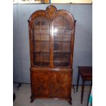 A Queen Anne standing display cabinet, having tri-arched design to top, with upper glazed section