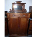 A Dutch cabinet, having galleried top with bevelled mirrored back, below a single drawer above a two