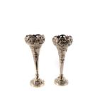 A pair of white metal continental posy vases, having pierced floral design to top, with lower shield
