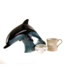 A pair of Poole pottery dolphins, in the form of dolphins jumping a wave, in the traditional blue