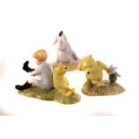 A selection of 9 Royal Doulton Winnie the Pooh figures, including Christopher Robin, Eeyore's