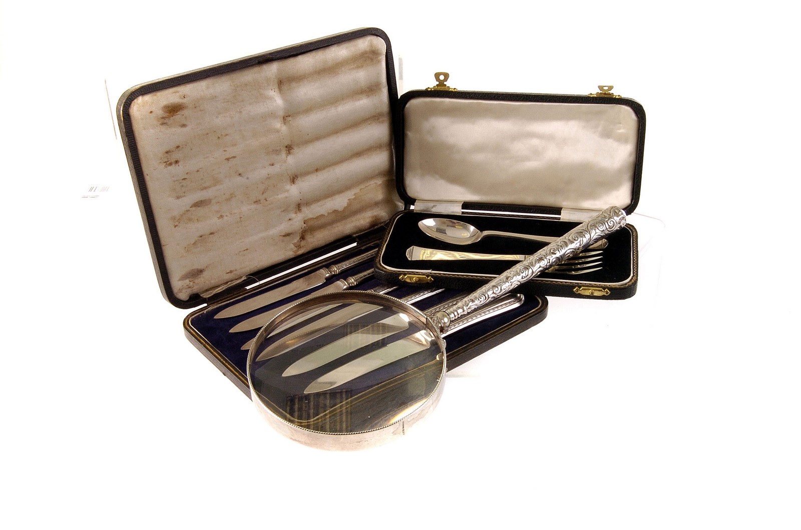 A collection of various silver items, including a German silver magnifying glass, with swag design