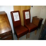 A pair of modern high back dining chairs, in brown leather