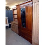 An unusual aesthetics walnut wardrobe,  with planked single door elevated section over a three