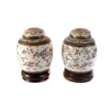 A pair of Samson ginger jars and covers, both having floral design and heightened with gilt