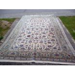 A large beige ground carpet, having decorative floral centre, flanked by a floral multi-border,