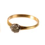 A diamond solitaire, the brilliant cut diamond mounted on a yellow metal band