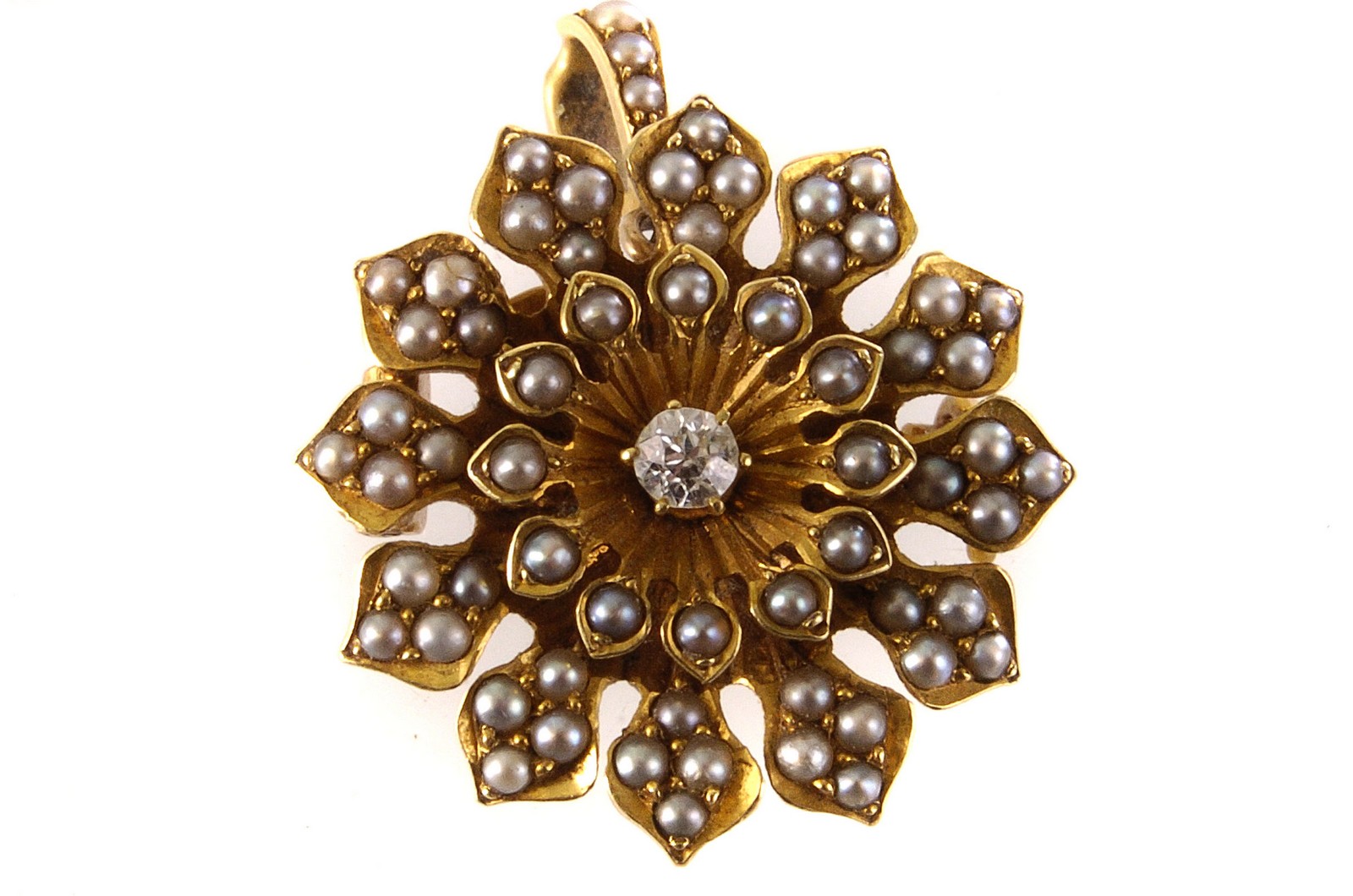 A seed pearl and diamond brooch, the central brilliant cut diamond surrounded by multiple seed