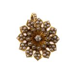 A seed pearl and diamond brooch, the central brilliant cut diamond surrounded by multiple seed