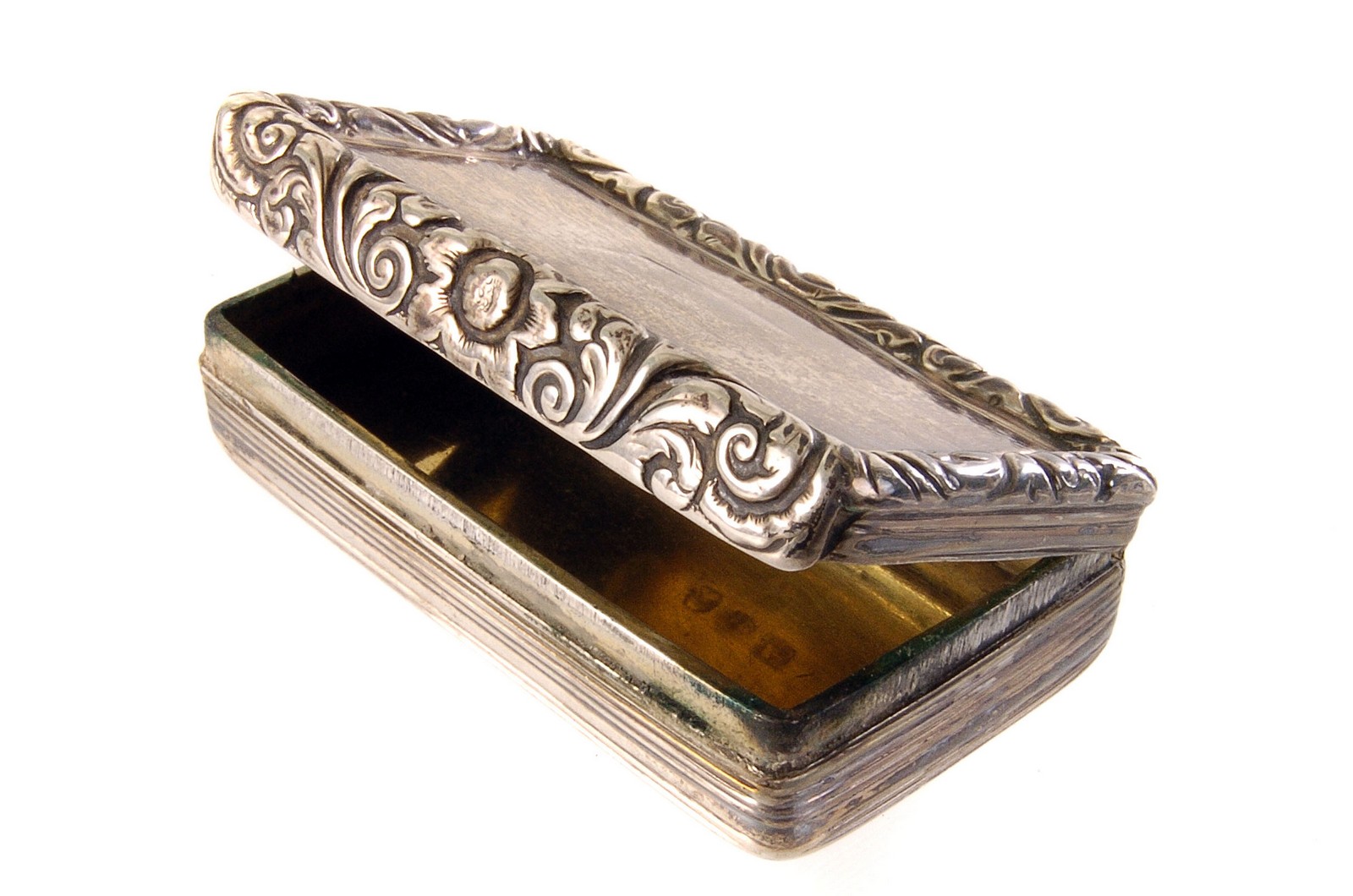 A George IV silver snuff box, with reeded base and floral lid, marked Birmingham 1824, by John