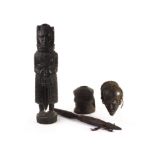 A group of three African tribal hardwood carved items, including a grain mortar and pestle, a carved