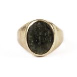 A gold and emerald signet ring, having a green hardstone with intaglio design, possibly Roman, in an