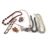 A group of five vintage necklaces and two brooches, including an antique mother of pear bead