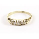 A vintage 18ct gold five stone diamond ring, with graduating old cuts in claw mounts, in retailers