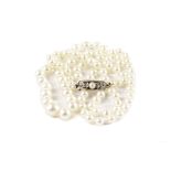 A modern cultured pearl necklace, single strand of graduating knotted string, on a 9ct gold clasp