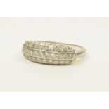 A pretty Art Deco period diamond dress ring, the stepped tablet set with three rows of brilliant cut