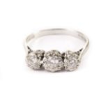 An 18ct gold three stone diamond ring, having graduated brilliant cuts in illusion white gold