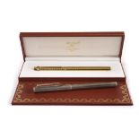 A Must de Cartier and a Dunhill pen, the gilt Cartier in box with papers, the textured plated