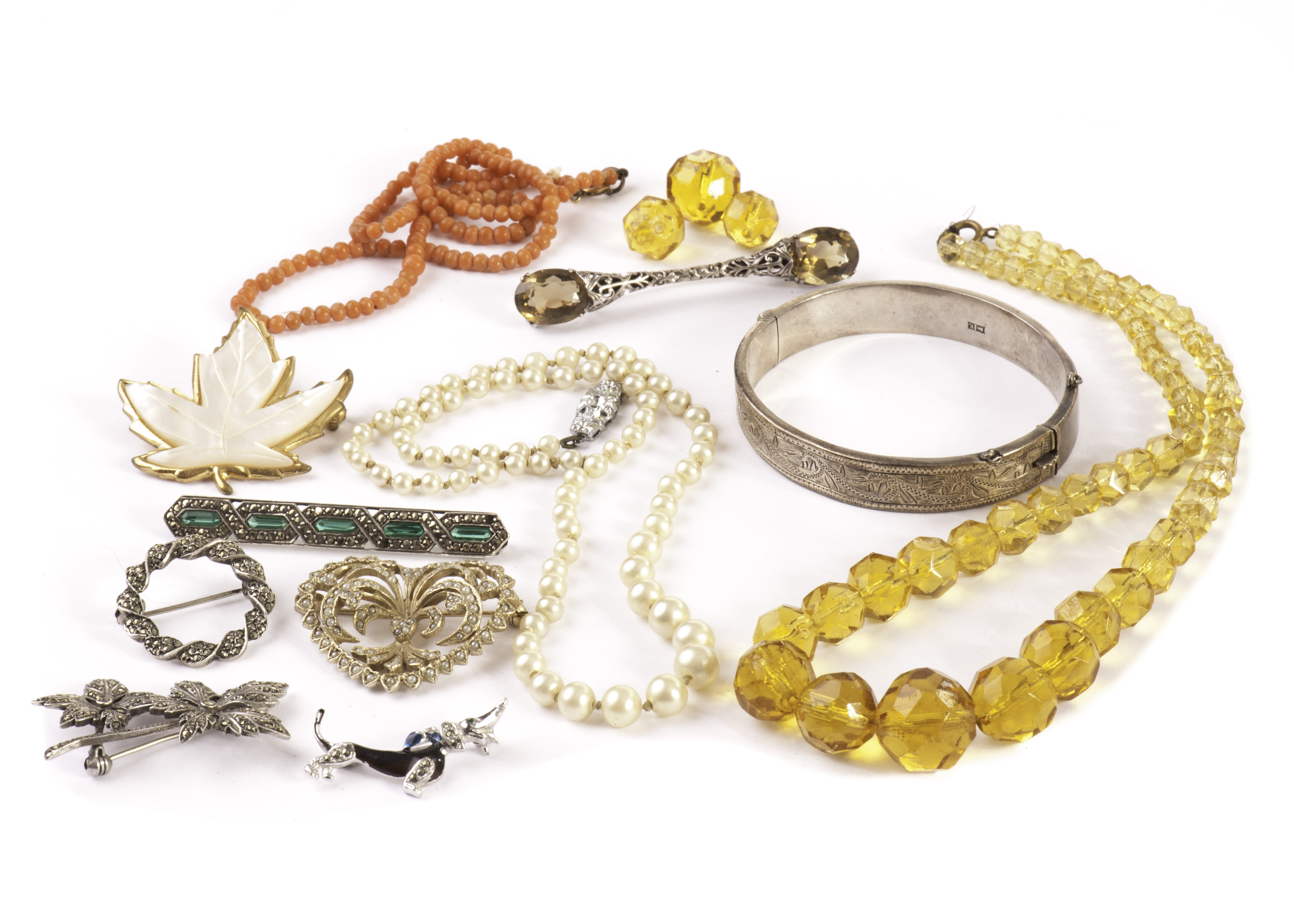 A small group of silver and other costume jewels, including a Scottish brooch, a small coral bead