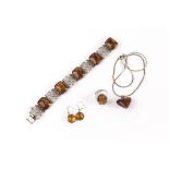 An associated suite of Baltic amber and silver jewellery, comprising a filigree and amber panel