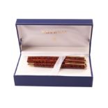 A modern trio Waterman pen set, possibly Liaison range in mottled brown, comprising fountain pen,