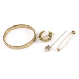 A 9ct gold bangle, together with a 9ct gold horseshoe and riding crop brooch, a yellow metal pin