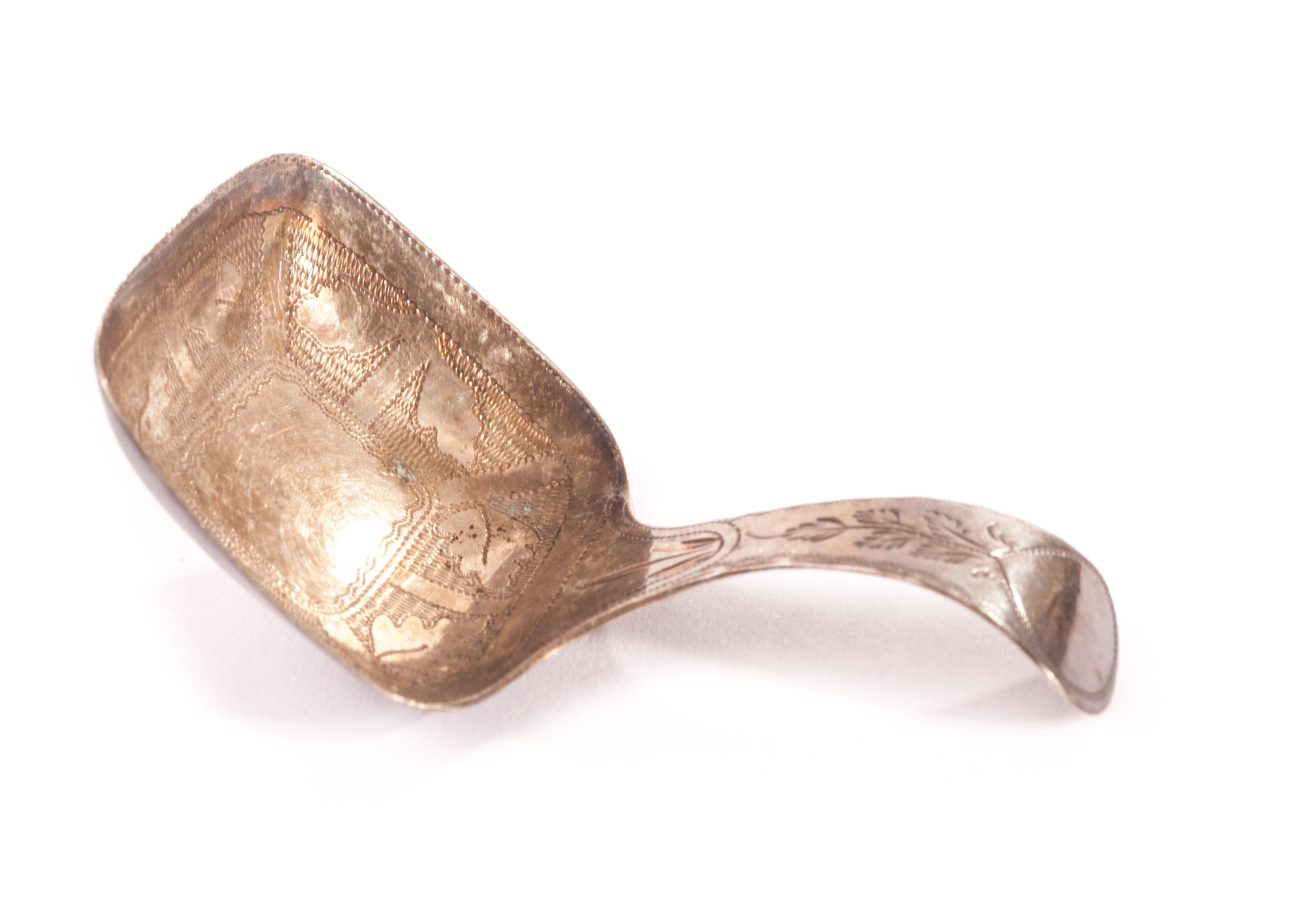 A George III silver tea caddy spoon J.W, with bright cut designs, bearing strike marks for