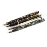 Three Waterman’s fountain pens, including a green marbled Junior, a brown marbled lever fountain