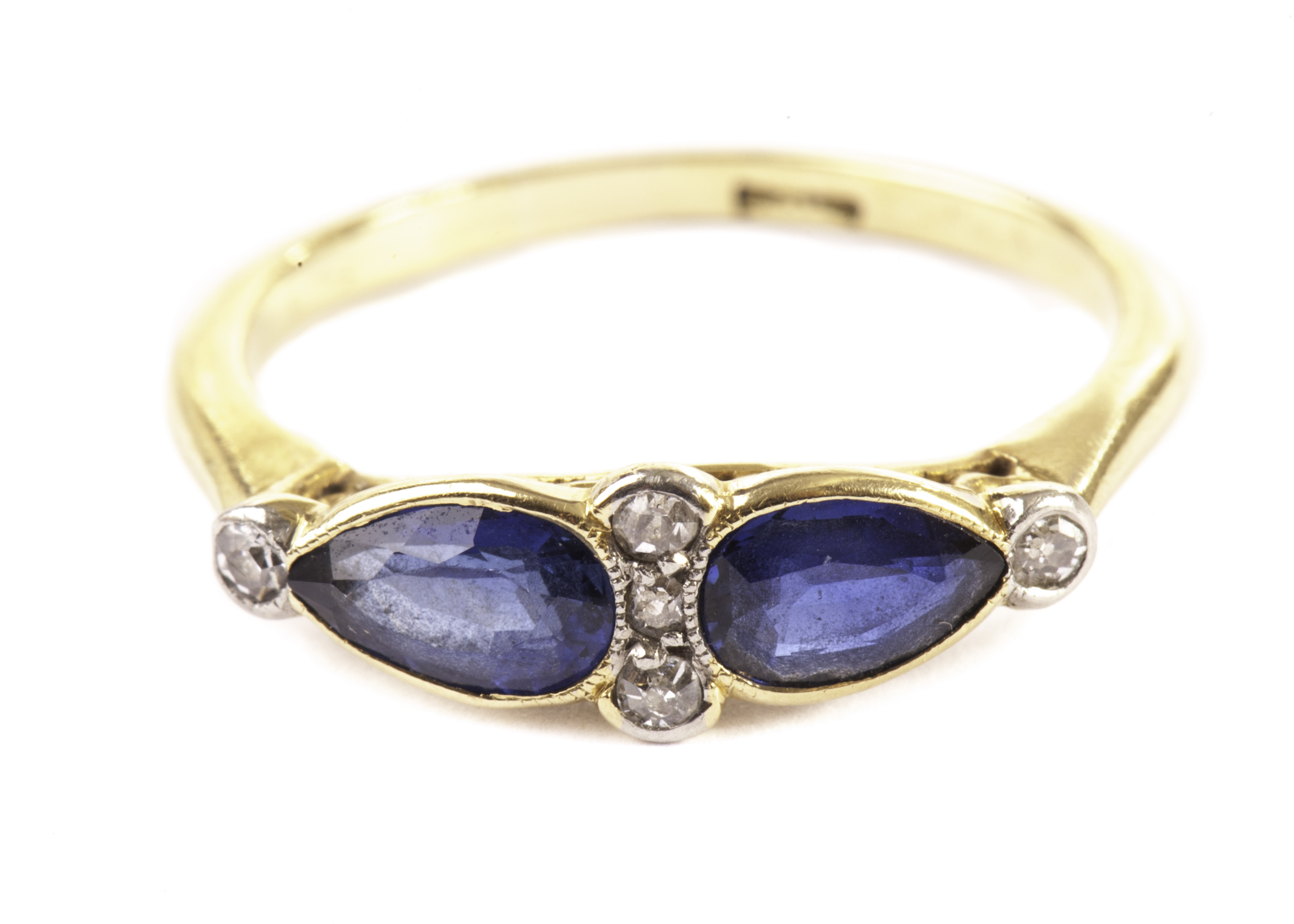 A pretty Edwardian period sapphire and diamond dress ring, having a pair of teardrop shaped good