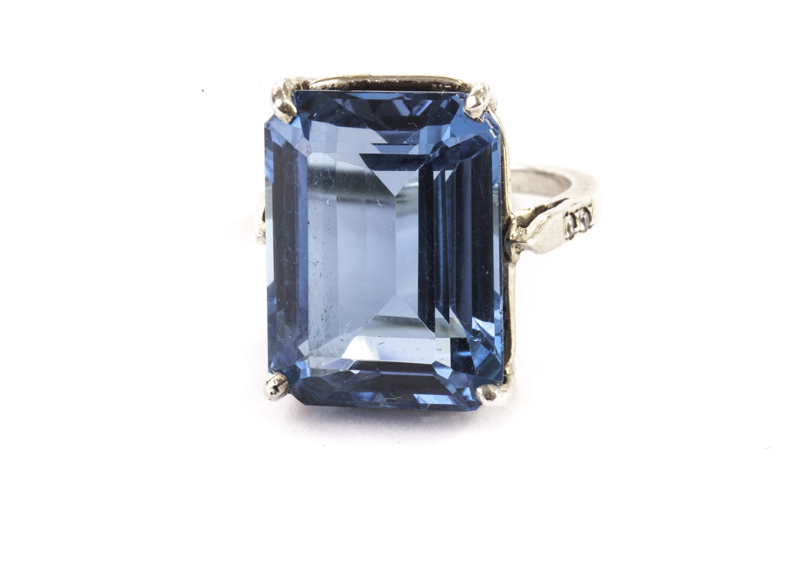 A silver and paste dress ring, having a large blue rectangular stone in four claw mount, marked 925