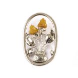 An Eastern European white metal and amber brooch, the stylish modelled as a framed potted plant with