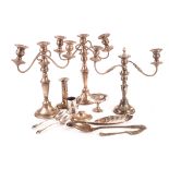 A collection of silver plated items, including candle holders, a wine bottle coaster, a basting