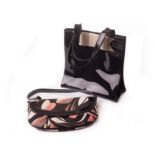 A Ted Baker black PVC lady’s handbag, together with a pink, lilac, black, and cream example (2) We