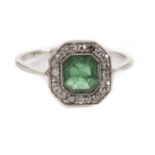 An Art Deco emerald and diamond dress ring, the octagonal tablet set with eight cuts with central