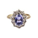 A sapphire and diamond cluster ring, the central oval light blue stone surrounded by brilliant