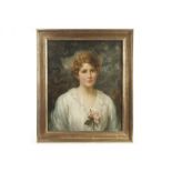 An early 20th century oil on canvas portrait, of a society lady with cropped hair holding a rose,