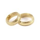 Two modern 18ct gold wedding bands, the his and hers rings with engraved rims, hallmarked, approx